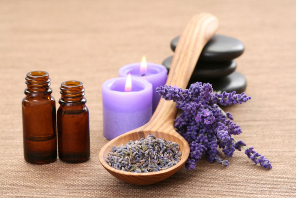 Aromaterapeutické zmesi esenciálnych olejov v miskách s kvetmi